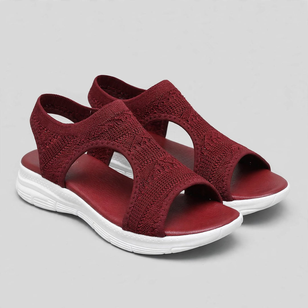 Deep burgundy open toe knitted sandals with white sole and matching stitching.