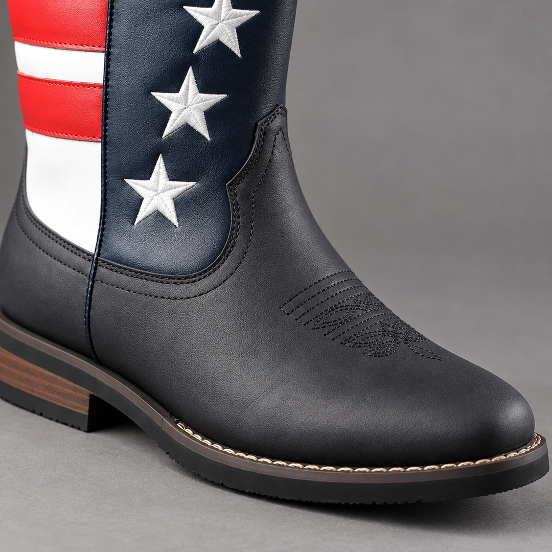 Mid-calf western boots in matte black with red, white and navy blue stars and stripes, black sole, brown heel. (detail macro)