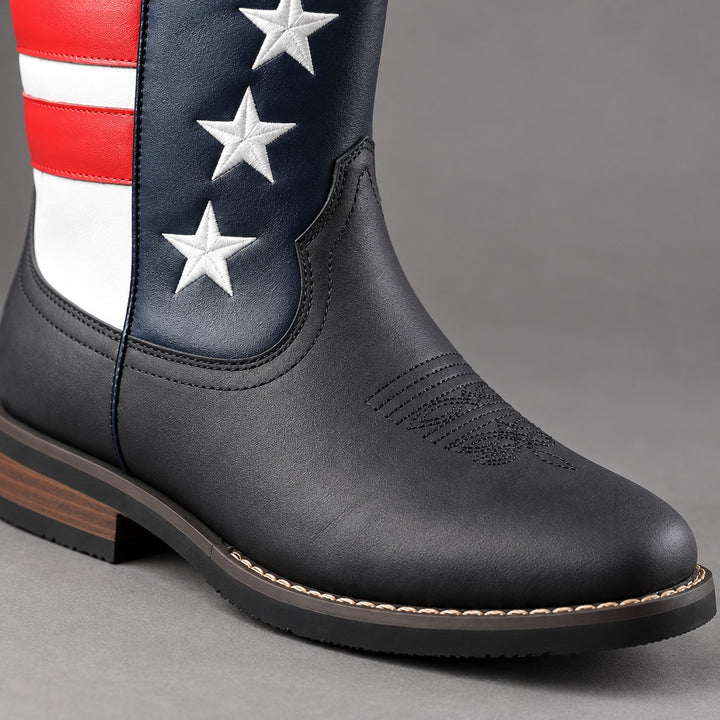 Mid-calf western boots in matte black with red, white and navy blue stars and stripes, black sole, brown heel. (detail macro)