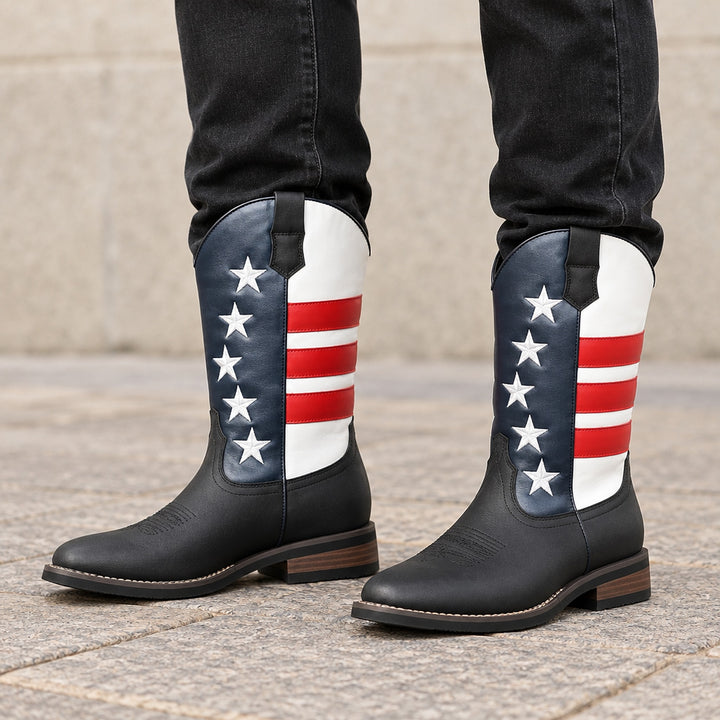 Mid-calf western boots in matte black with red, white and navy blue stars and stripes, black sole, brown heel. (on model)