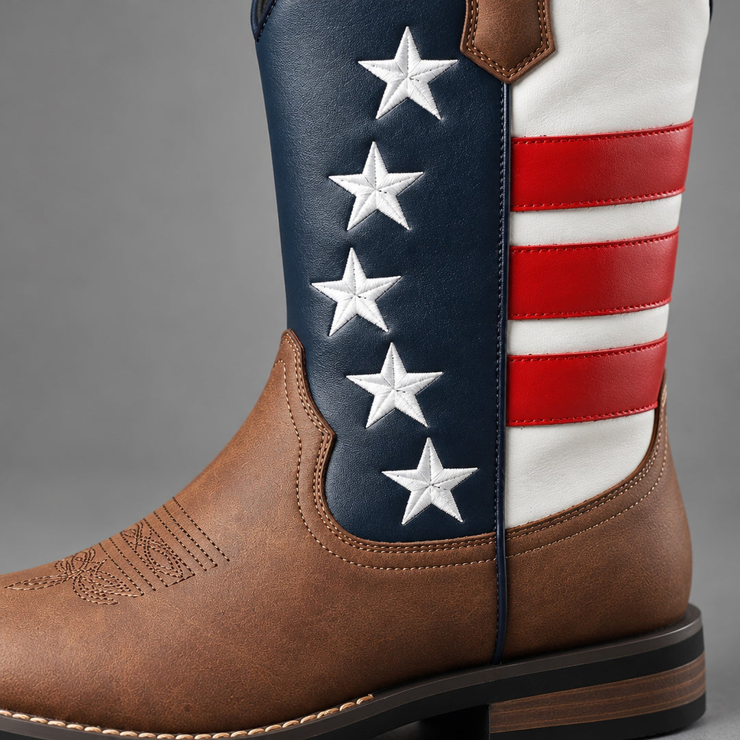Mid-calf western boots in matte brown with navy, white and red stars and stripes, black sole, brown heel. (detail macro)