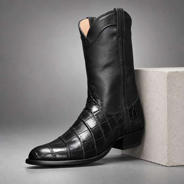 Black mid-calf western boots with glossy upper and glossy reptile-pattern panel on lower part. (plinth)
