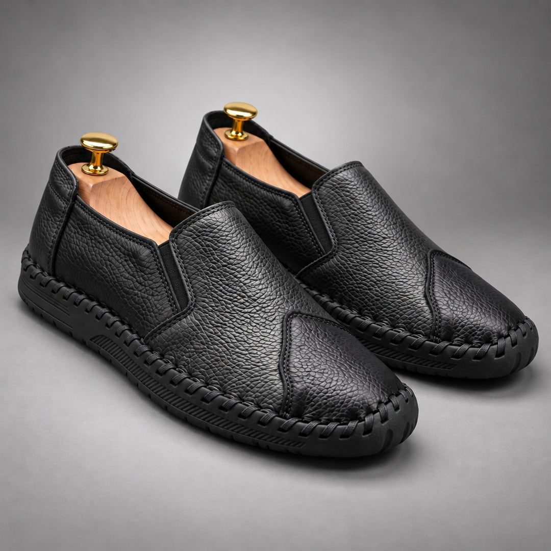 Loafers with a black pebbled body and a black sole.