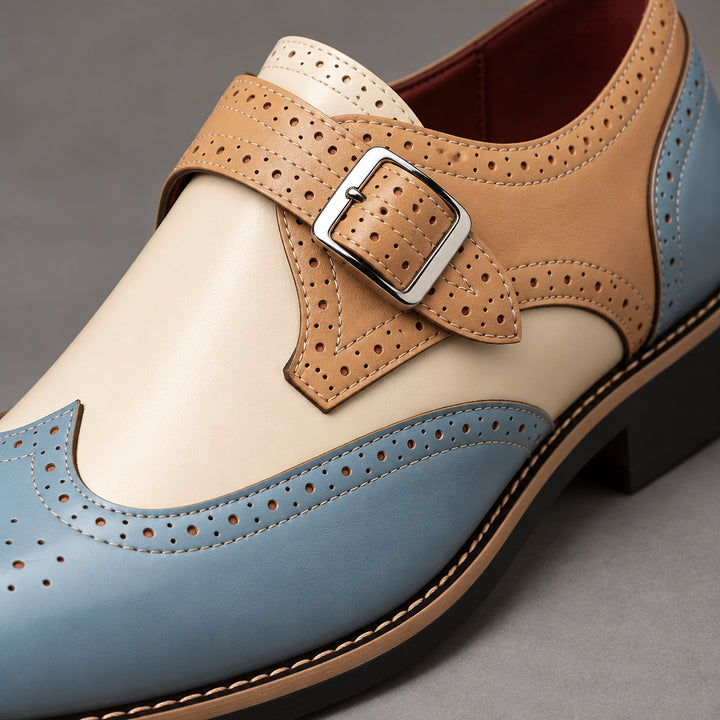 Loafers in light blue and beige with cream detail stitching and a silver buckle. (detail macro)