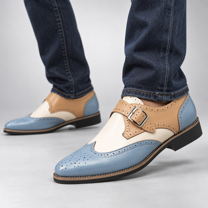 Loafers in light blue and beige with cream detail stitching and a silver buckle. (on model)