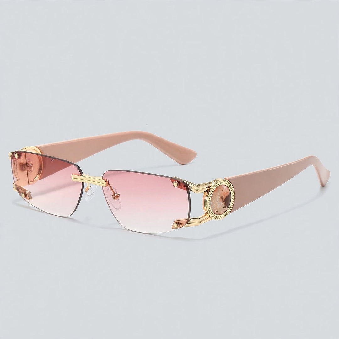 These sunglasses display glossy pink temples, gold metal details, and pink gradient lenses.