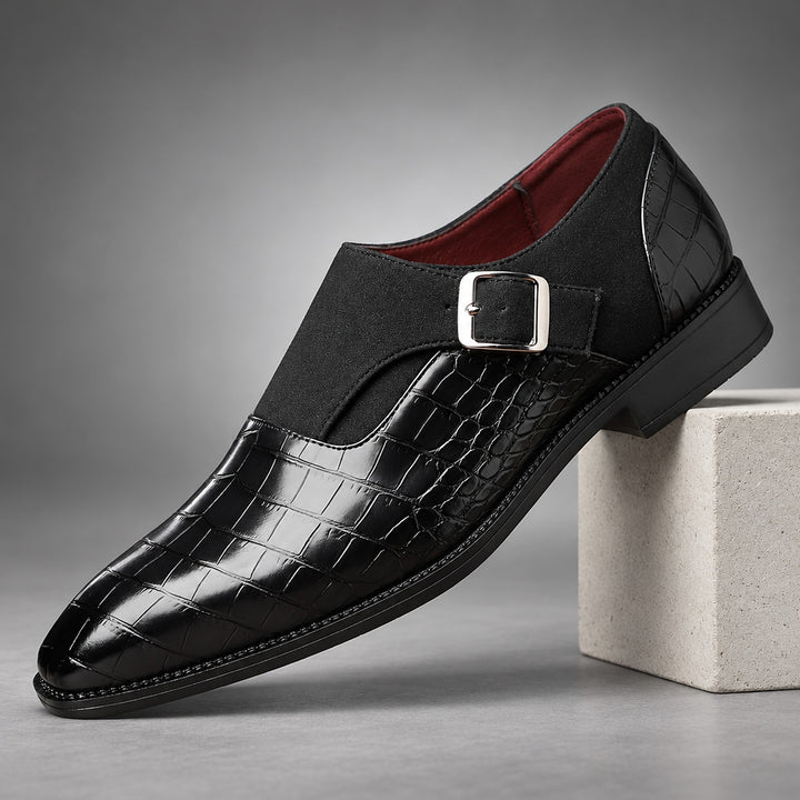 Glossy crocodile pattern black loafers with a silver buckle and black sole.