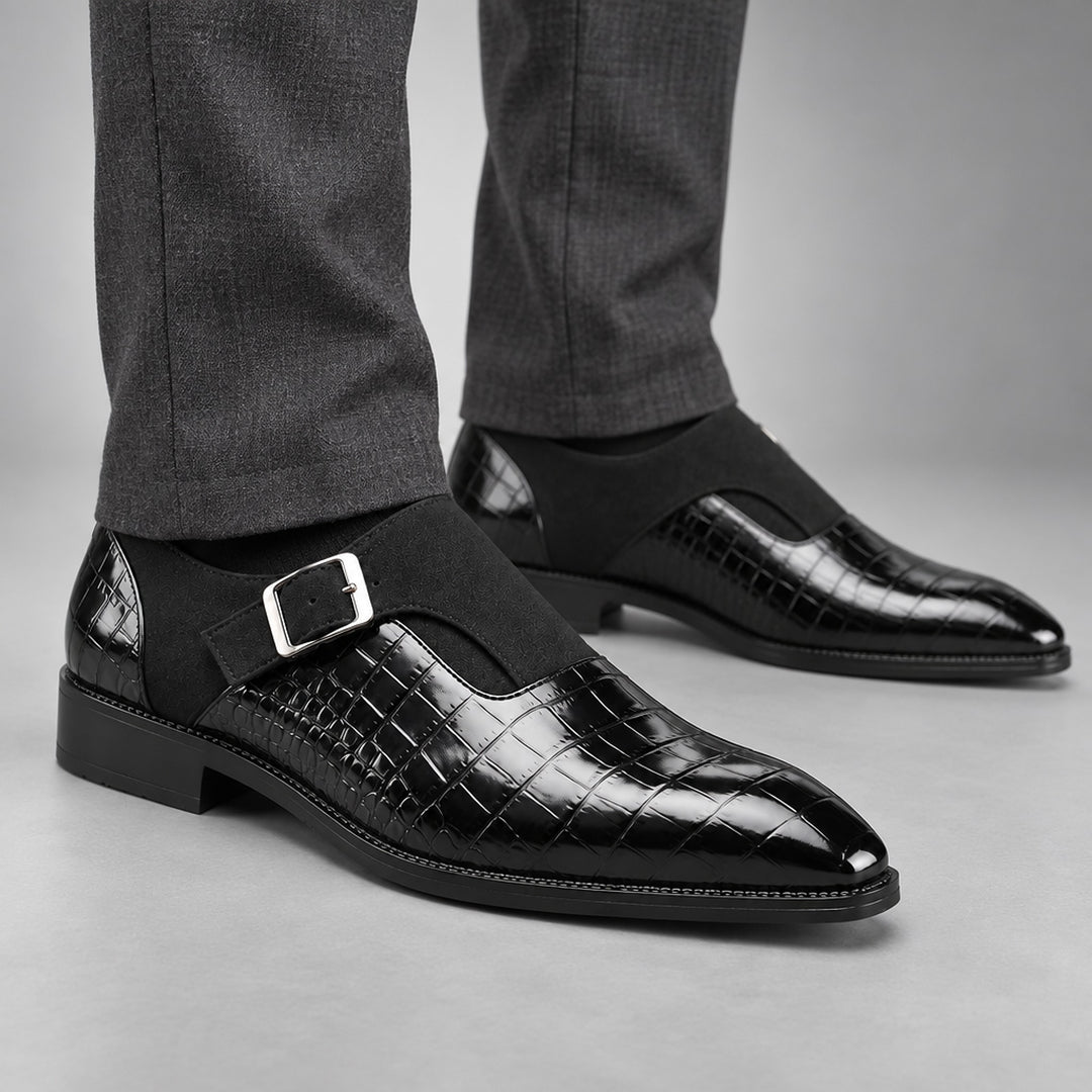 Glossy crocodile pattern black loafers with a silver buckle and black sole. (on model)