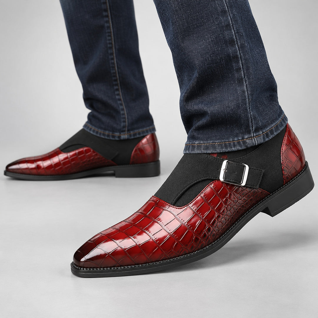 Glossy crocodile pattern burgundy loafers with a silver buckle and black sole. (on model)