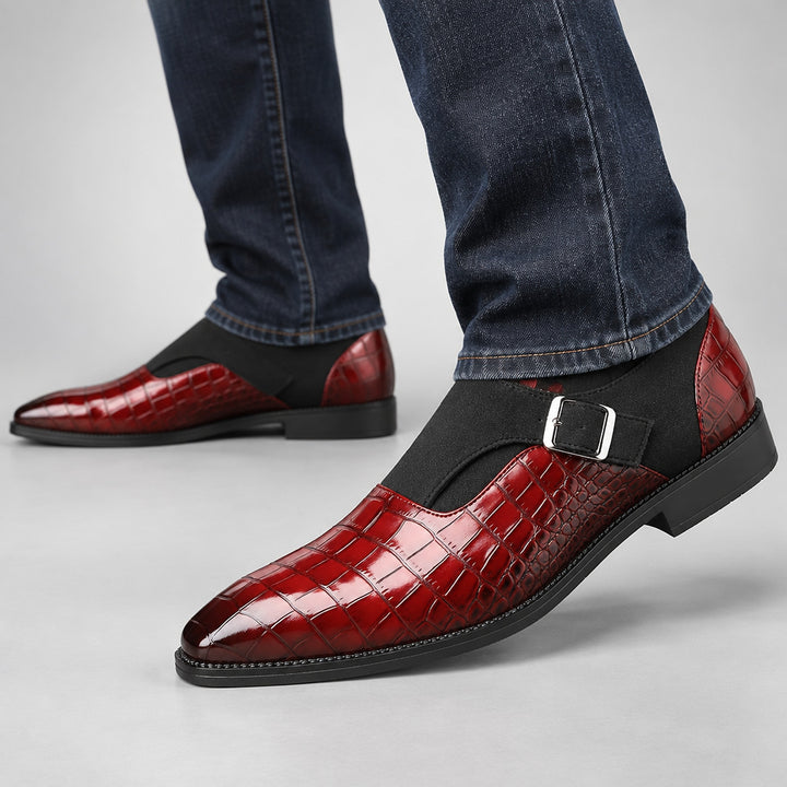 Glossy crocodile pattern burgundy loafers with a silver buckle and black sole. (on model)