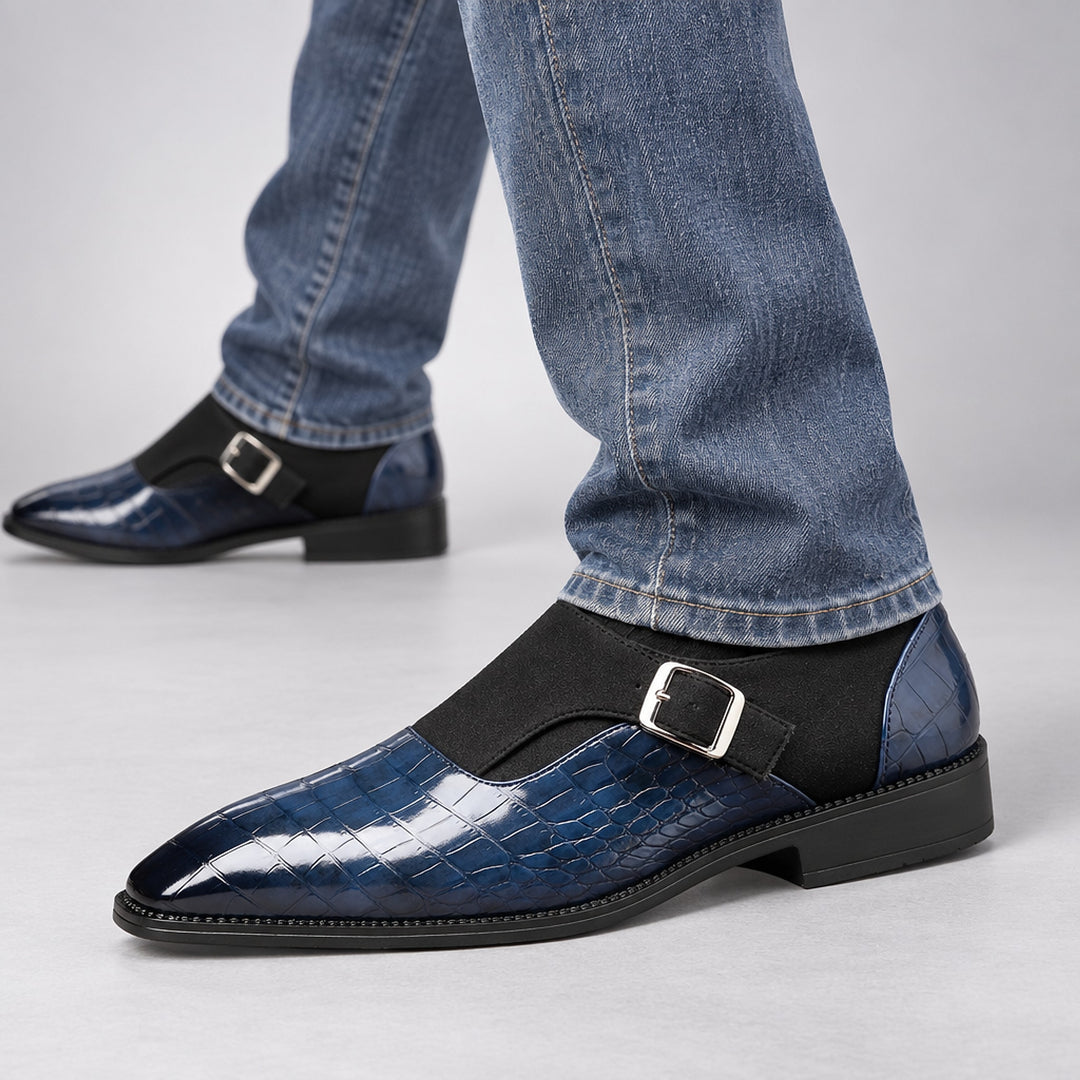 Glossy crocodile pattern navy loafers with a silver buckle and black sole. (on model)