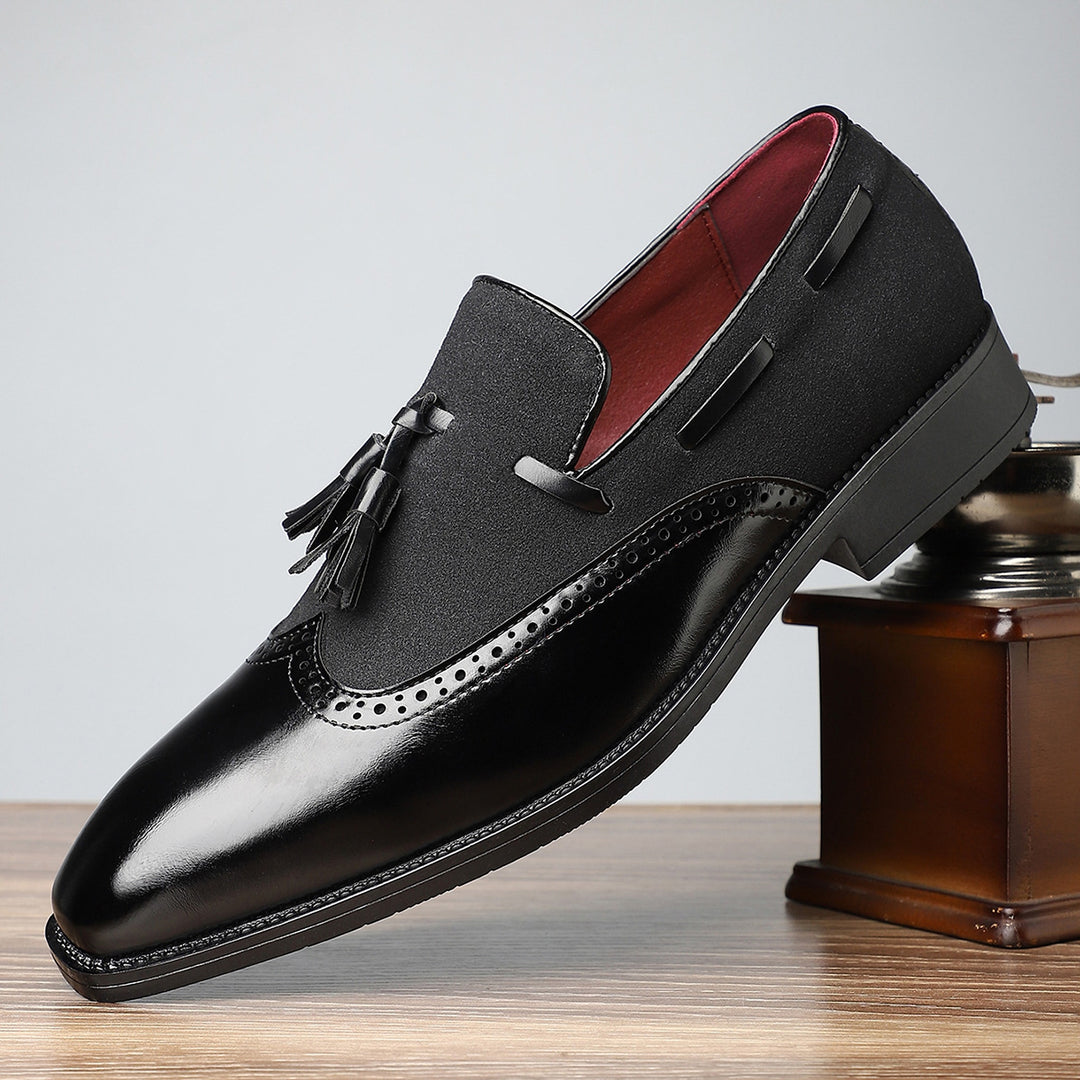 Black shoes with a mix of glossy leather and matte textured fabric, finished with black stitching.