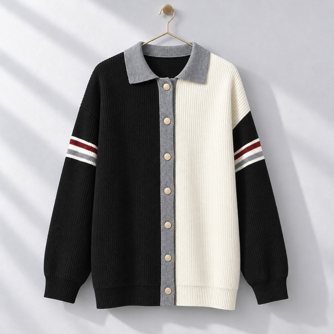 Cardigan sweater with a black left side, cream right side, matte beige buttons, and medium gray trim. (hanging)