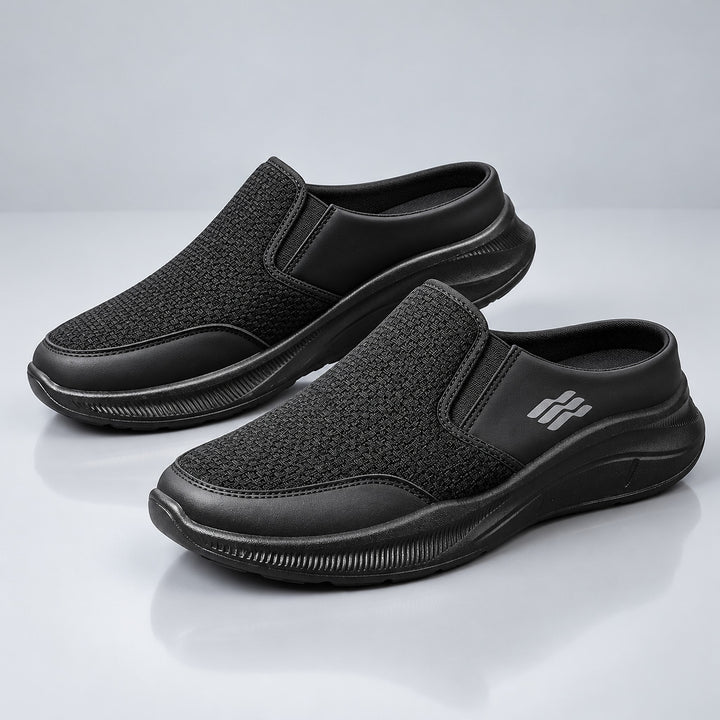 Black backless slip-on shoes with a black sole and matte finish