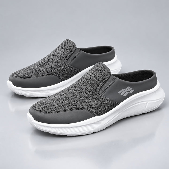 Dark gray backless slip-on shoes with a white sole and matte finish