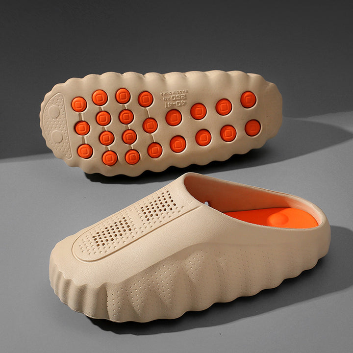 Matte warm beige slip-on shoes with matching thick beige sole and orange circular accents.