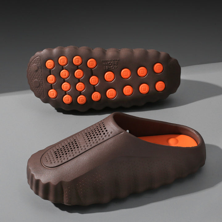 Matte dark brown slip-on shoes with thick brown sole and orange circular grips.