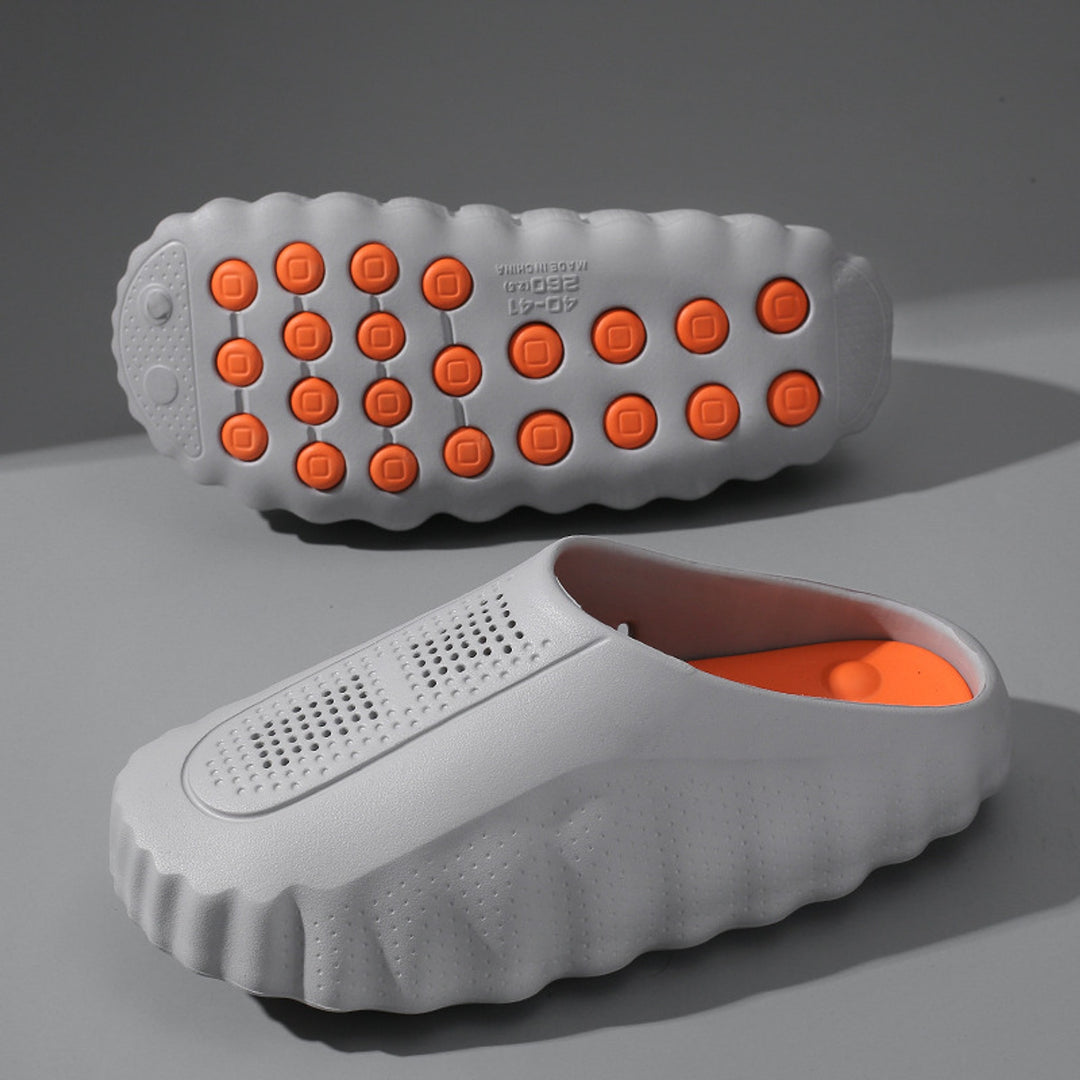 Light gray matte slip-on shoes with thick gray sole and orange grips.