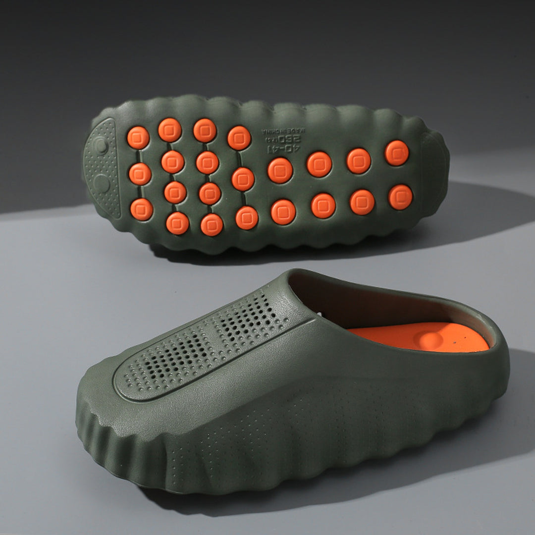 Matte olive green slip-on shoes with thick olive sole and orange circular grips.