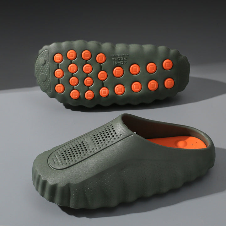 Matte olive green slip-on shoes with thick olive sole and orange circular grips.