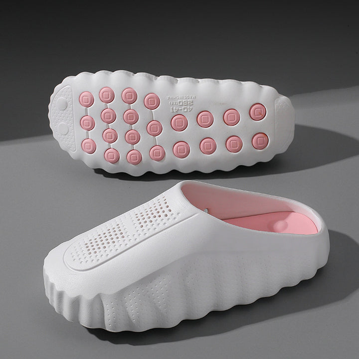 Soft white matte slip-on shoes with thick white sole and pink circular accents.