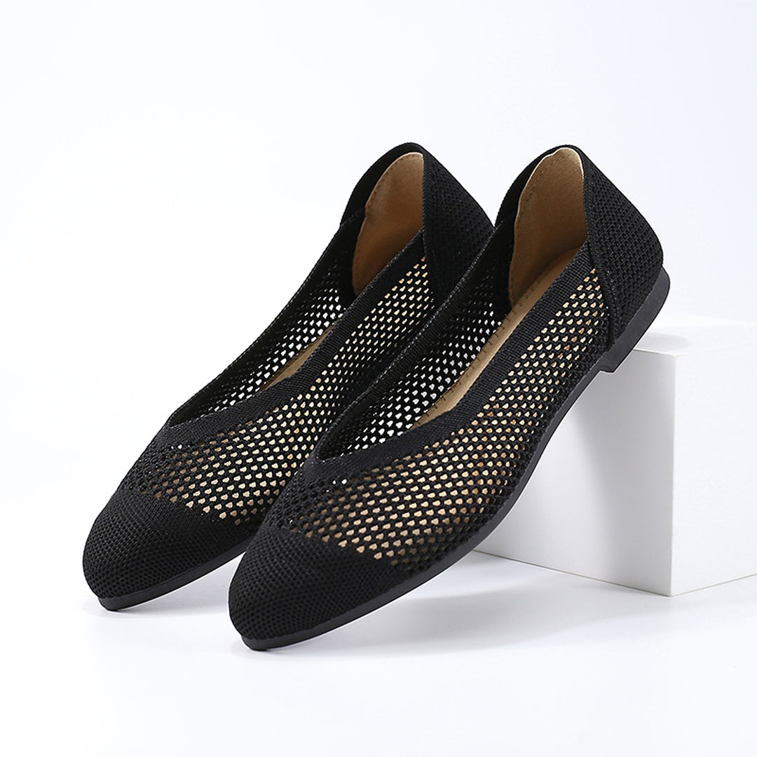 A black ballet flat in knitted fabric with a black sole and a matte look.