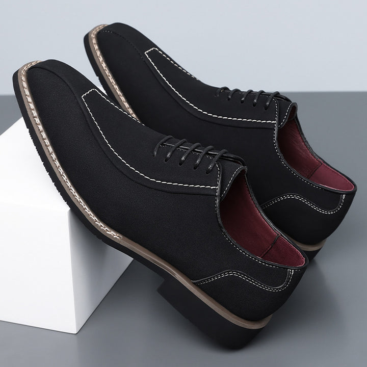 Matte black oxfords with cream stitching and a black sole edged in light brown. (photo 2)