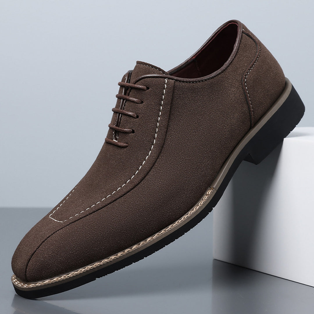 Matte dark brown oxfords with white stitching and a black sole edged in light brown.