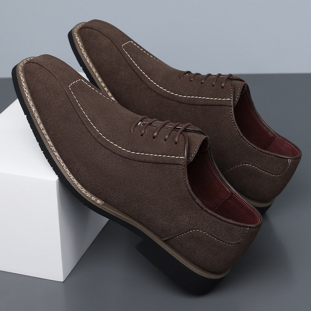 Matte dark brown oxfords with white stitching and a black sole edged in light brown. (photo 2)