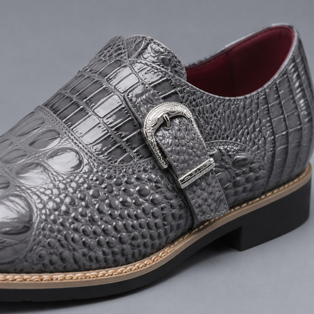 Glossy gray loafers with black sole, tan edge stitch, silver buckle and crocodile pattern upper.