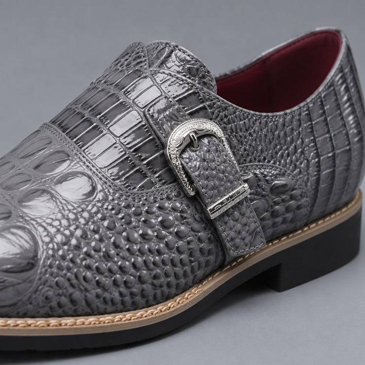 Glossy gray loafers with black sole, tan edge stitch, silver buckle and crocodile pattern upper.