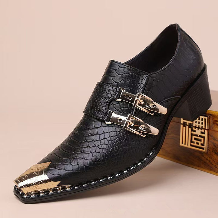 Black loafers with a glossy embossed reptile pattern and gold metal pointed toe cap.