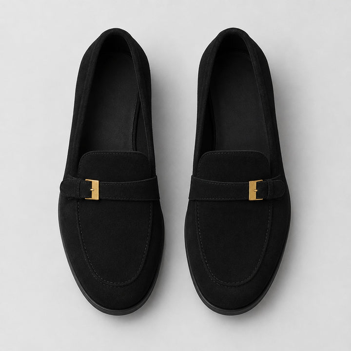 Matte black suede-look loafers with a black sole and gold buckle. (top down)