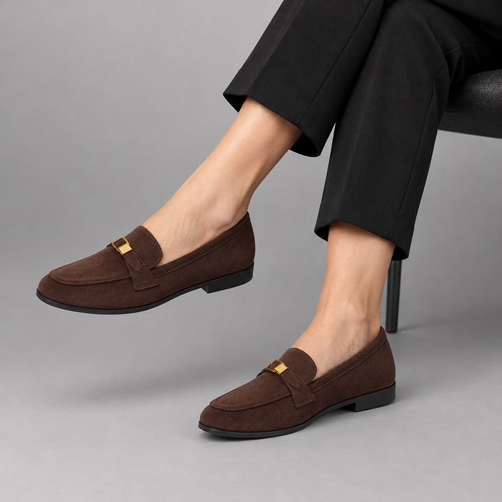 Matte dark brown suede-look loafers with a black sole and gold buckle.
