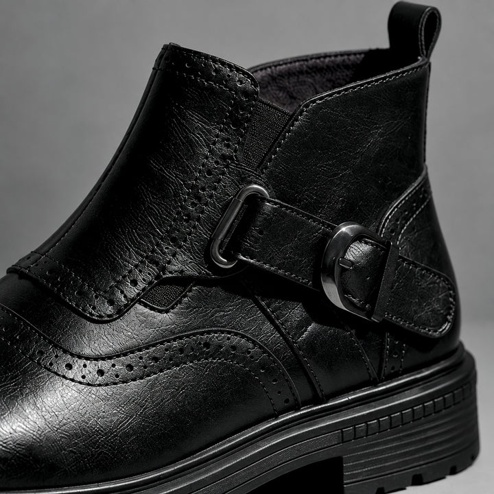 Boot in smooth black leather with black sole and a gunmetal buckle. (detail macro)