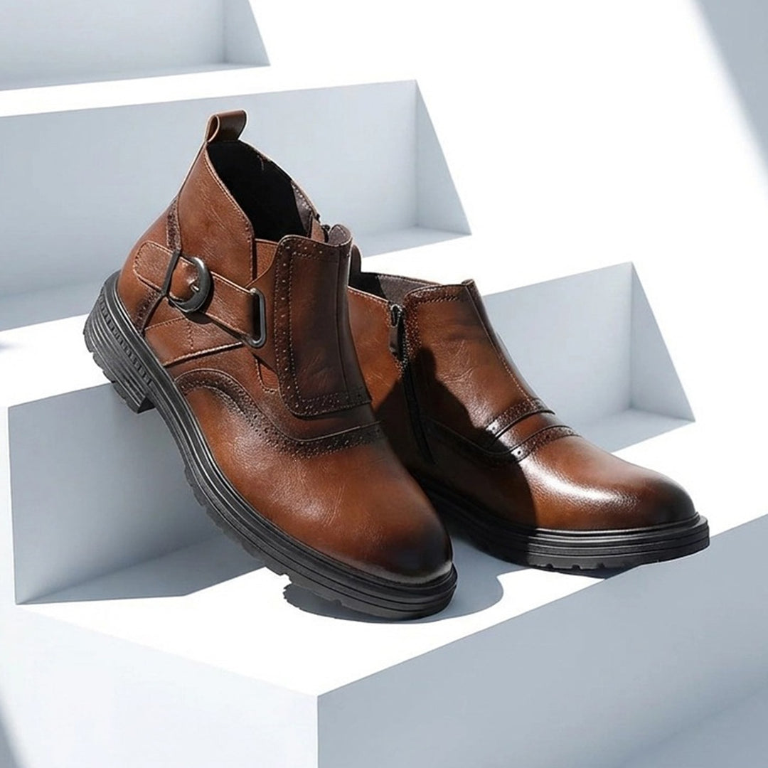 Boot in warm medium brown leather with a black sole and a dark gunmetal buckle. (photo 2)